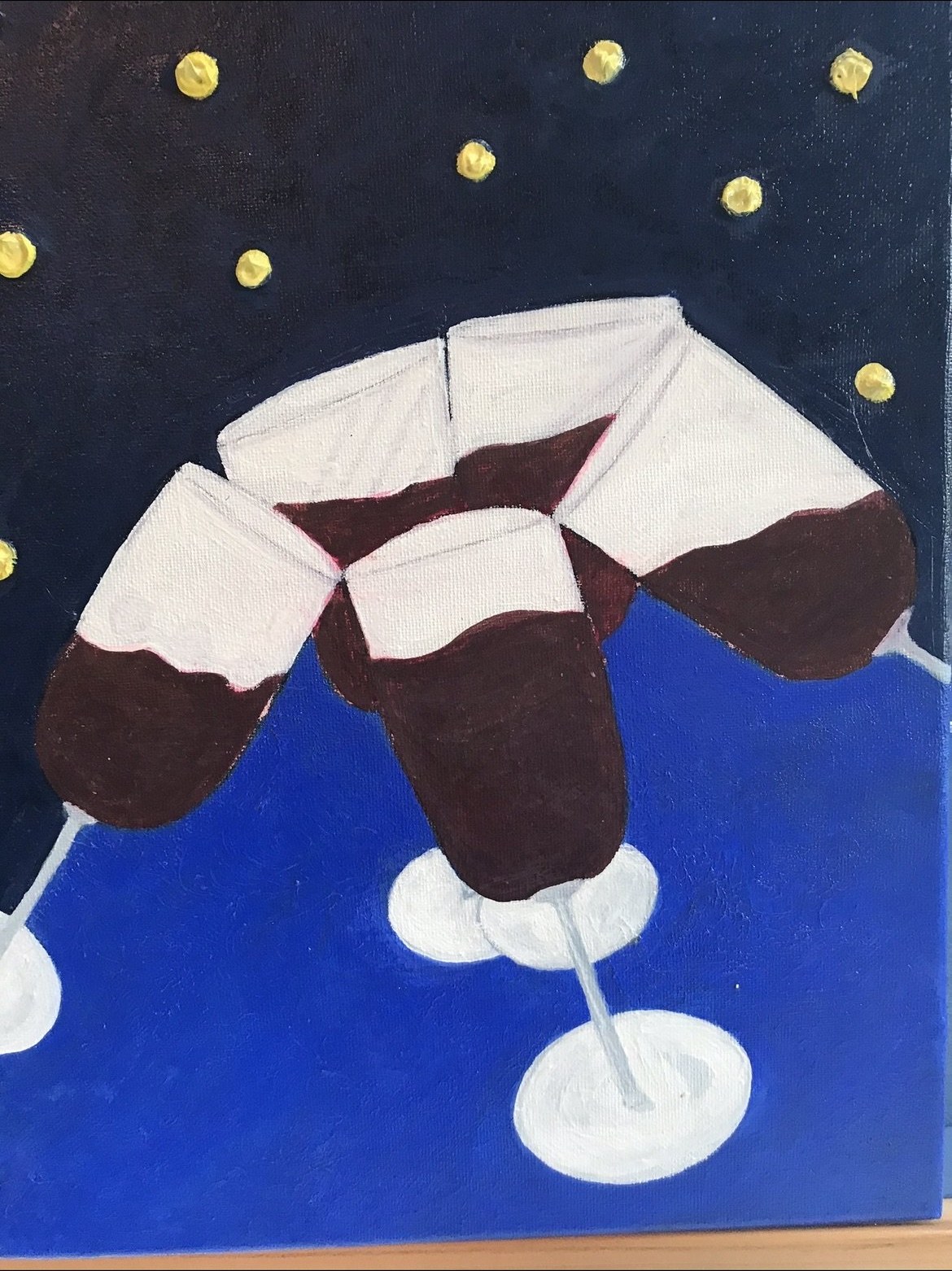 Folk-style painting of brown and cream mittens above white ice skates against a deep navy starry sky and bright blue ice